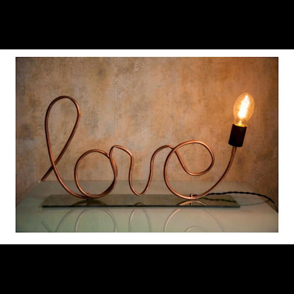 Brass “love” decor with lightbulb accent